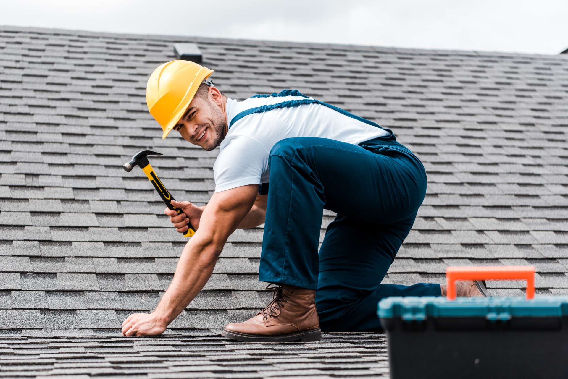 selective-focus-of-handsome-handyman-repairing-roo-5HJCQU9-2-1.jpg